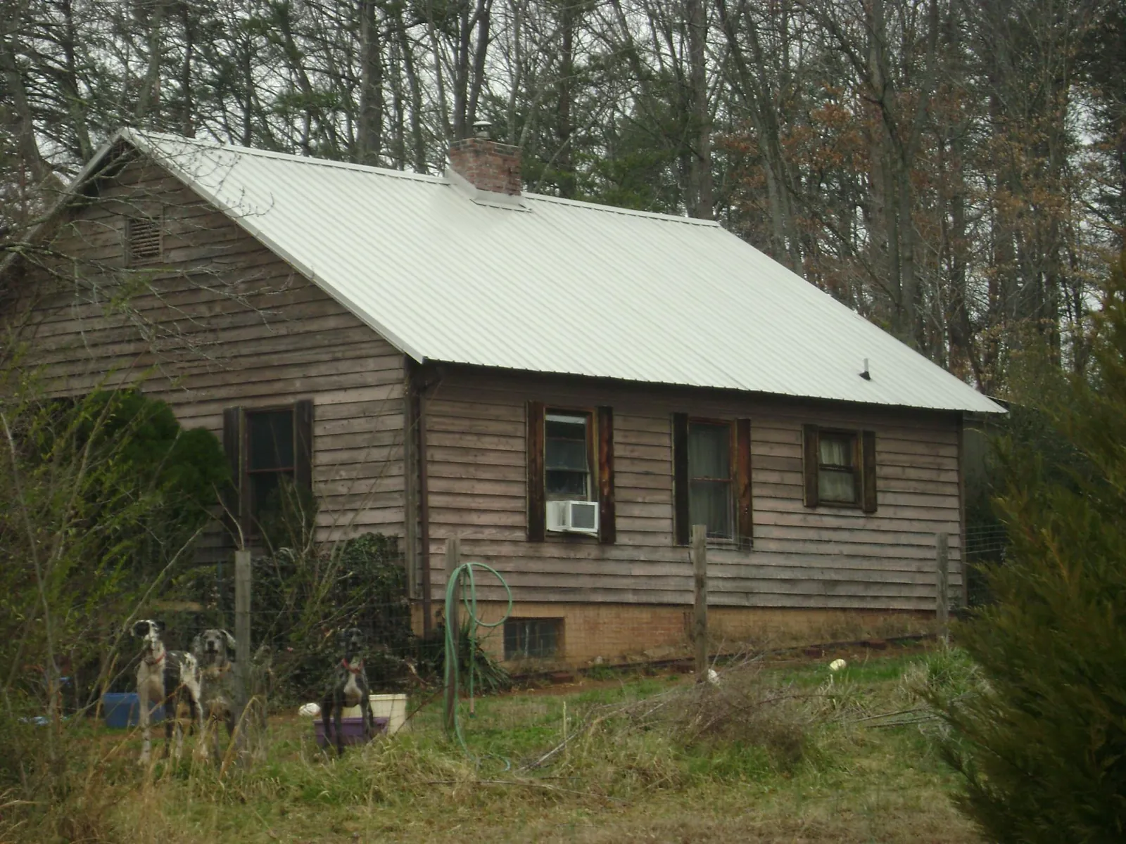 White metal roof on an old wood sided farmhouse, from a Metal Roof Installation job in Hestand